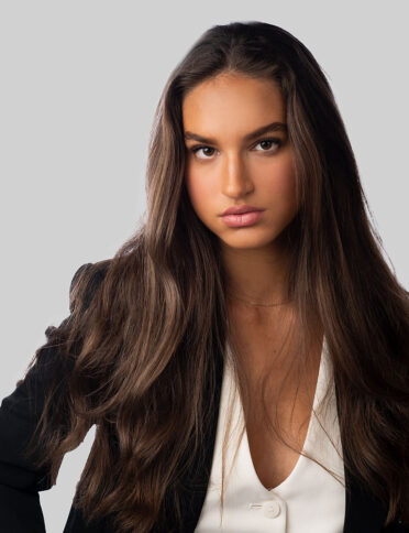 a young woman with long hair posing for a photo.