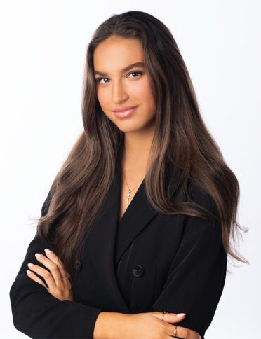 a young woman in a black suit posing for a photo.