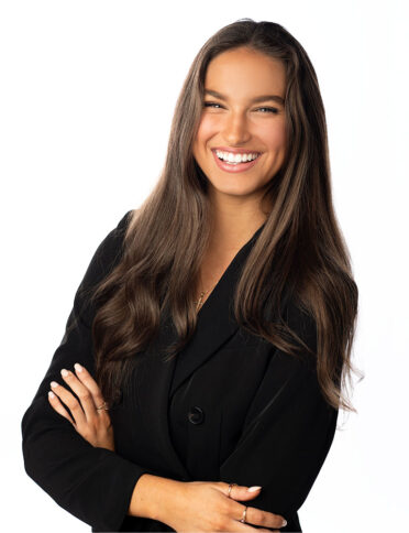 a smiling woman in a black suit.