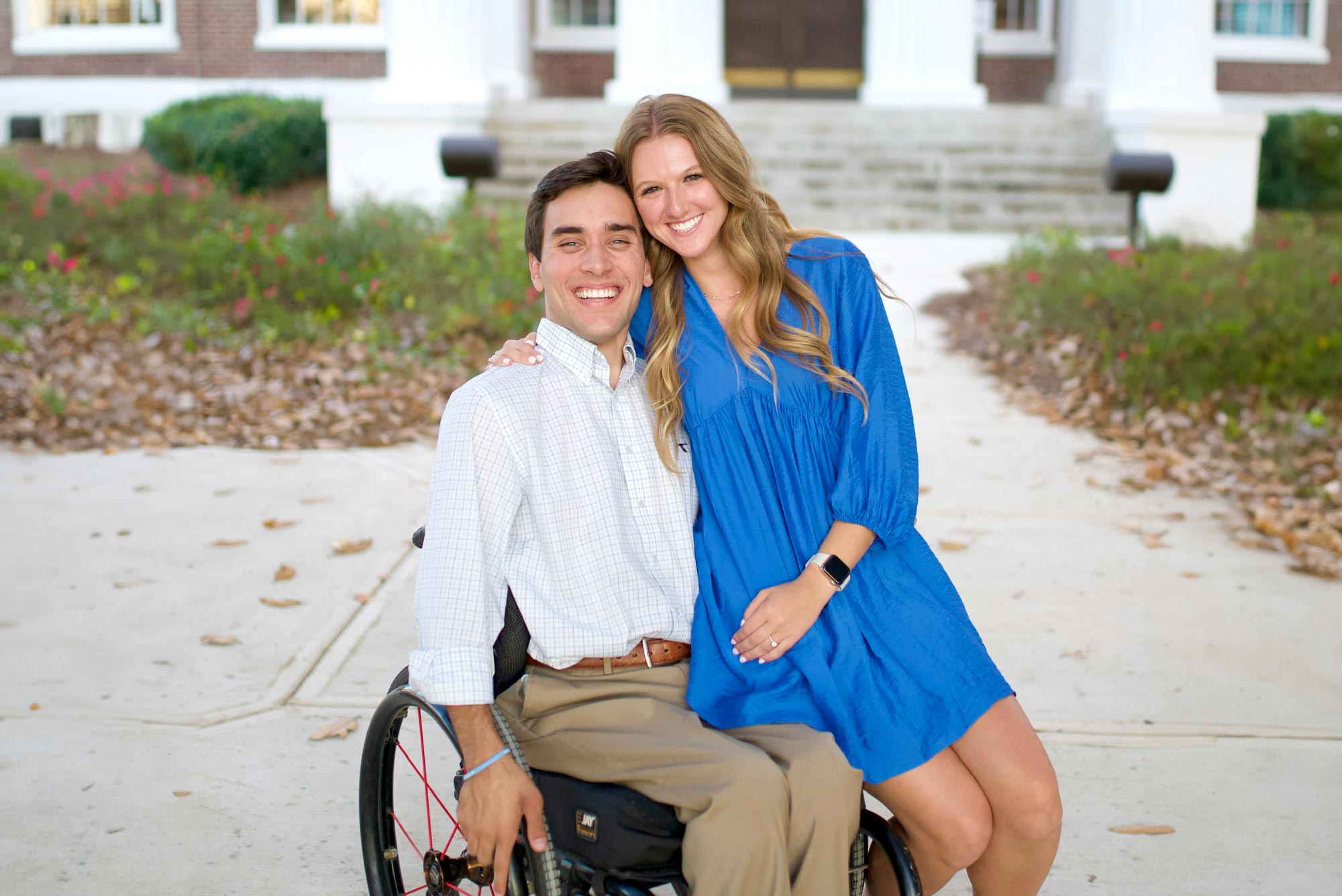 A man and woman in a wheelchair posing for a photo.