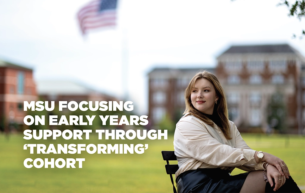 Young lady sitting outside on the campus of a university