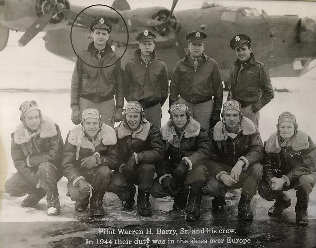 A group of WWII pilots and crew in front of a bomber, wearing flight gear. One pilot is circled in the back row. A caption notes their duty over Europe in 1944.