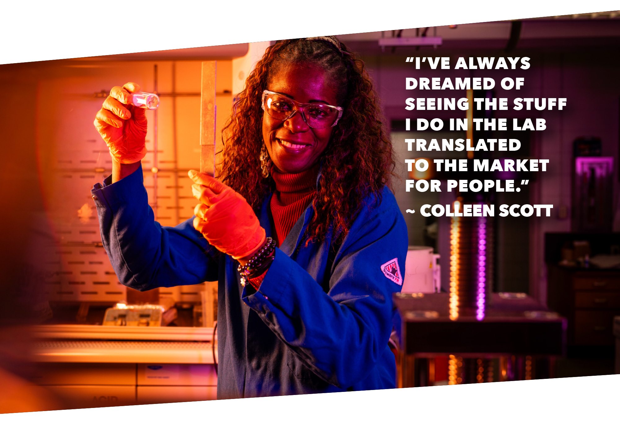A scientist in a lab coat and orange gloves holds a vial, with lab equipment in the background. A quote from Colleen Scott about translating lab work to the market is displayed beside her.