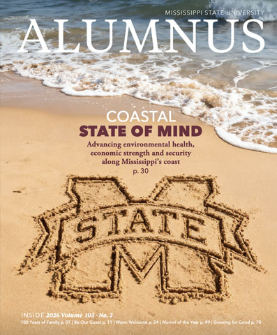 Mississippi State logo drawn in sand on a beach with ocean waves; “Coastal State of Mind” headline on Mississippi State University Alumnus magazine cover.